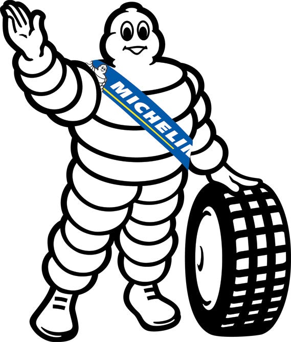 bibendum michelin sign brand and text logo french tyres car figurine mascot  on the roof of an ancient van Stock Photo
