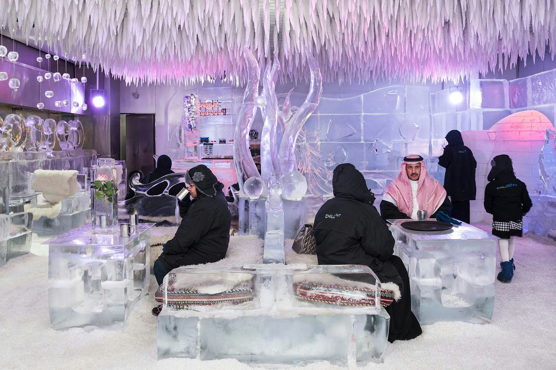 Chillout Ice Lounge, Dubai, January 2016. Saudi tourists having a hot chocolate at the Chillout Ice Lounge, the first ice lounge in the Middle East. Complete with ice sculptures, ice seating and tables, all at a subzero temperature. © Nick Hannes.