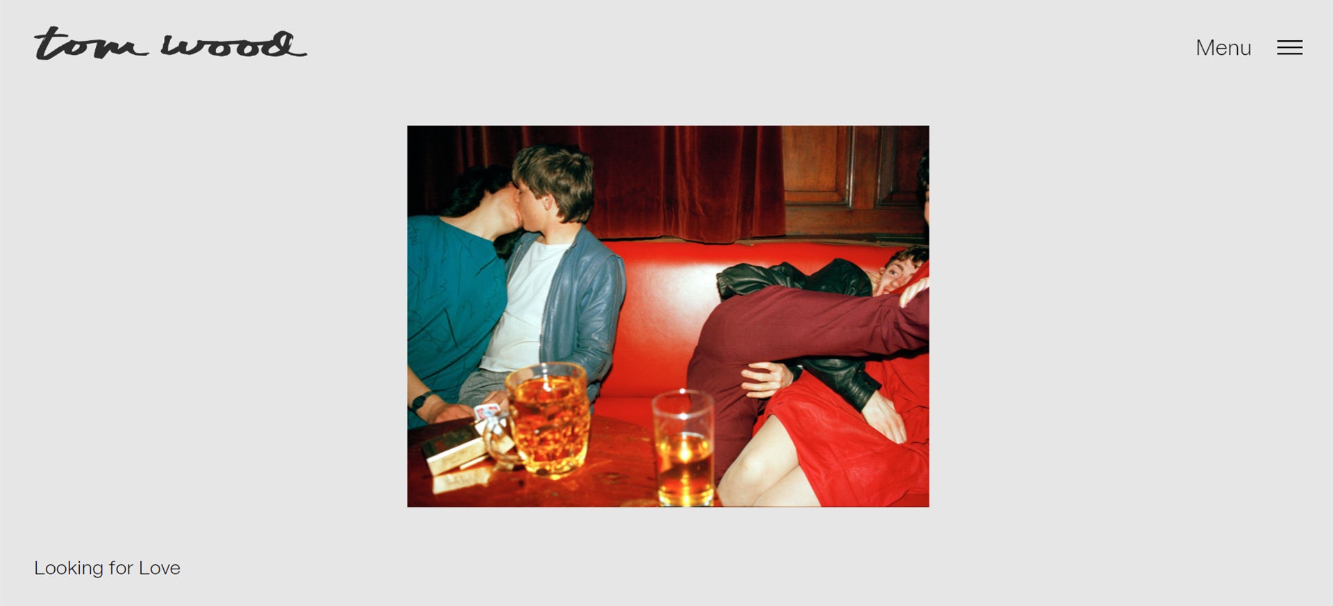 Homepage of Tom Wood's archive website, featuring a photograph of couples kissing in a bar