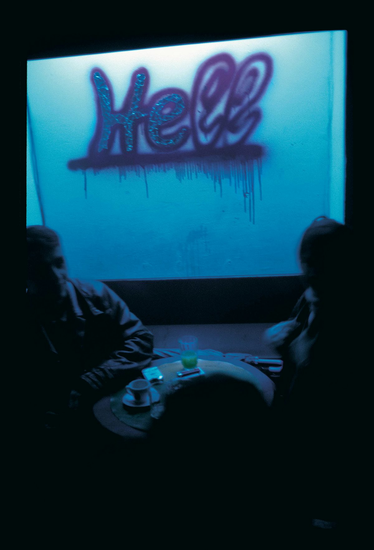 Photograph of the word 'hell' spraypainted onto a window from Robin Graubard book Road to Nowhere