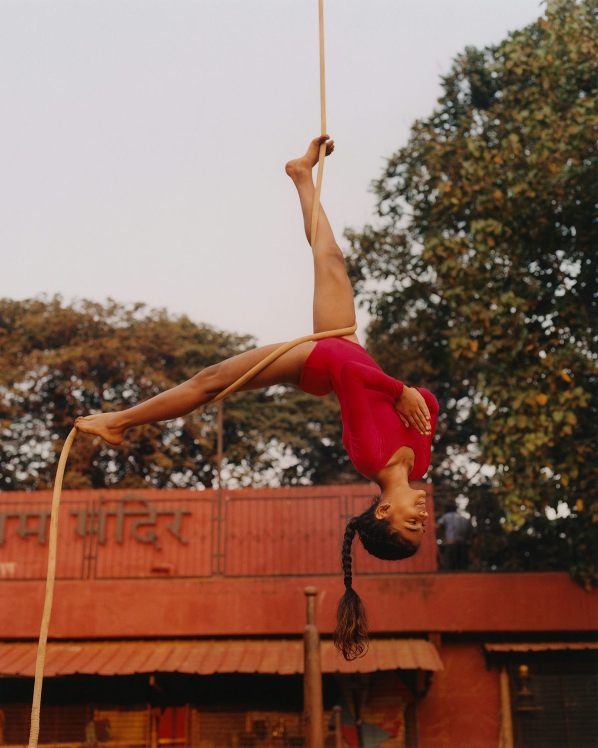 Young person practising mallakhamb in Vivek Vadoliya's book