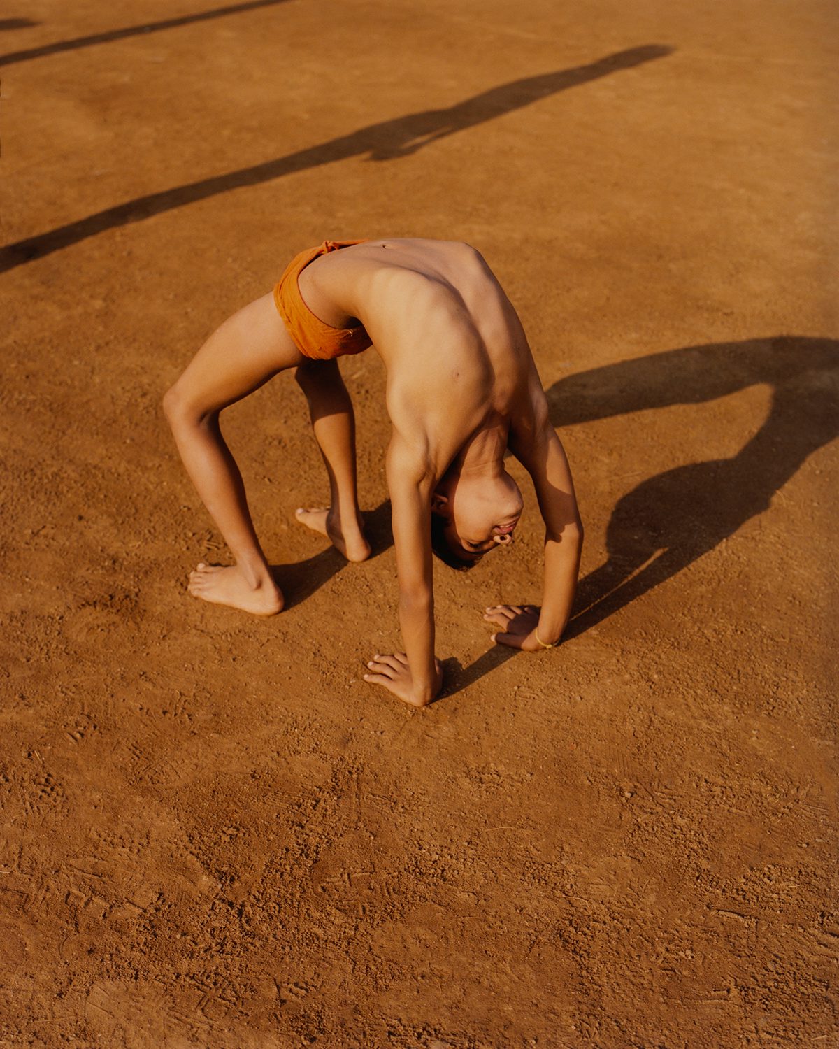 Photograph of a person on all fours in Vivek Vadoliya's book Mallakhamb