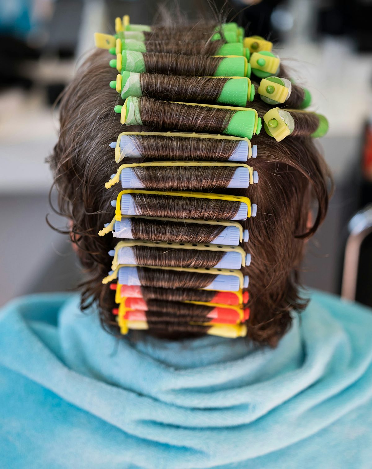 Photograph of the back of a person's head wearing hair rollers by Magnum photographer Rafal Milach