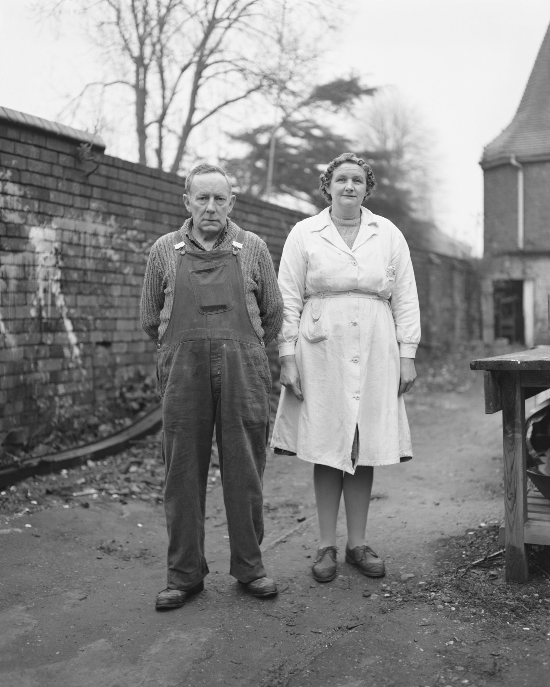 Black and white photograph of two people in uniform, which features in Life As It Is by John Myers