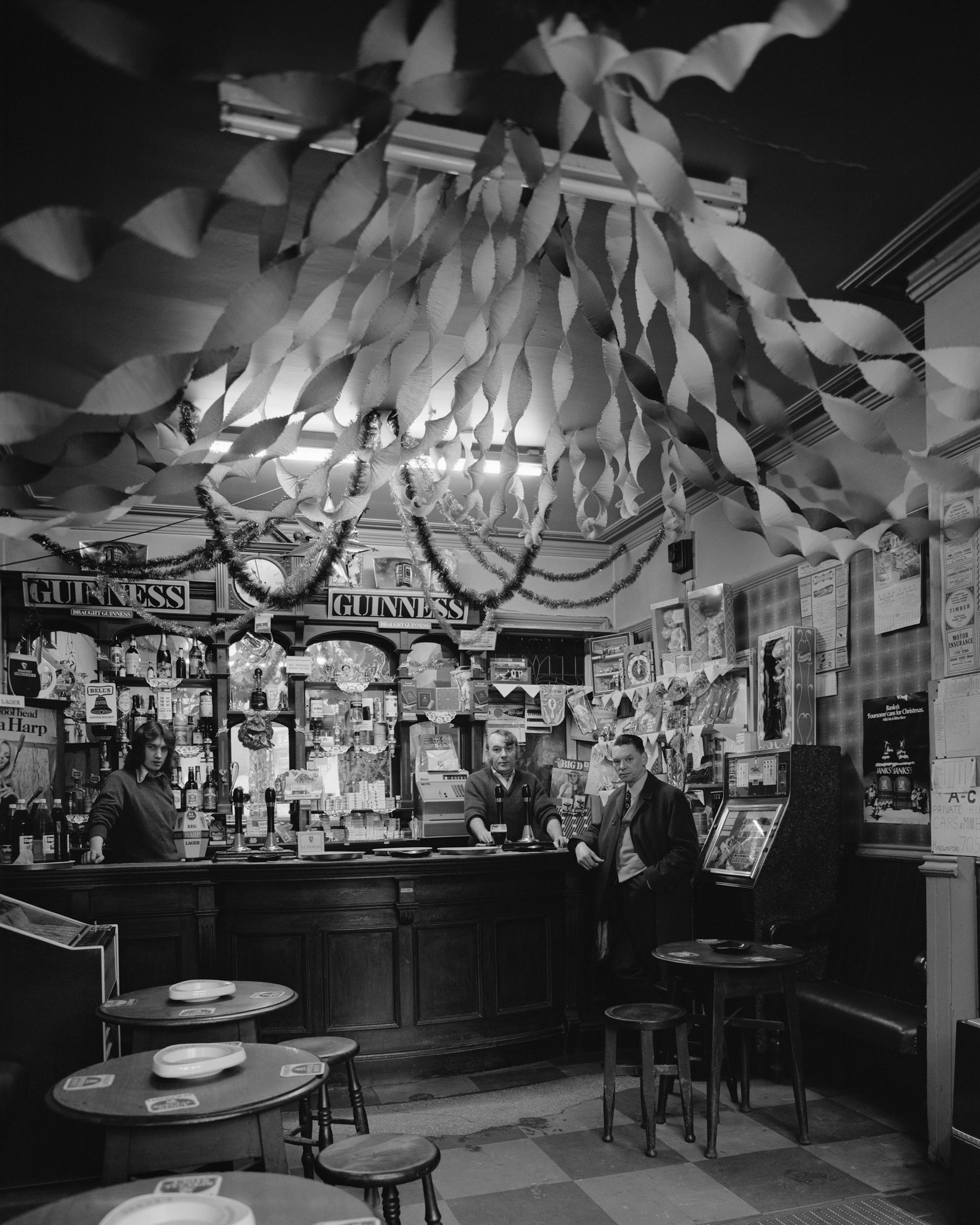 Black and white photograph of ceiling decorations inside a pub, which features in Life As It Is by John Myers