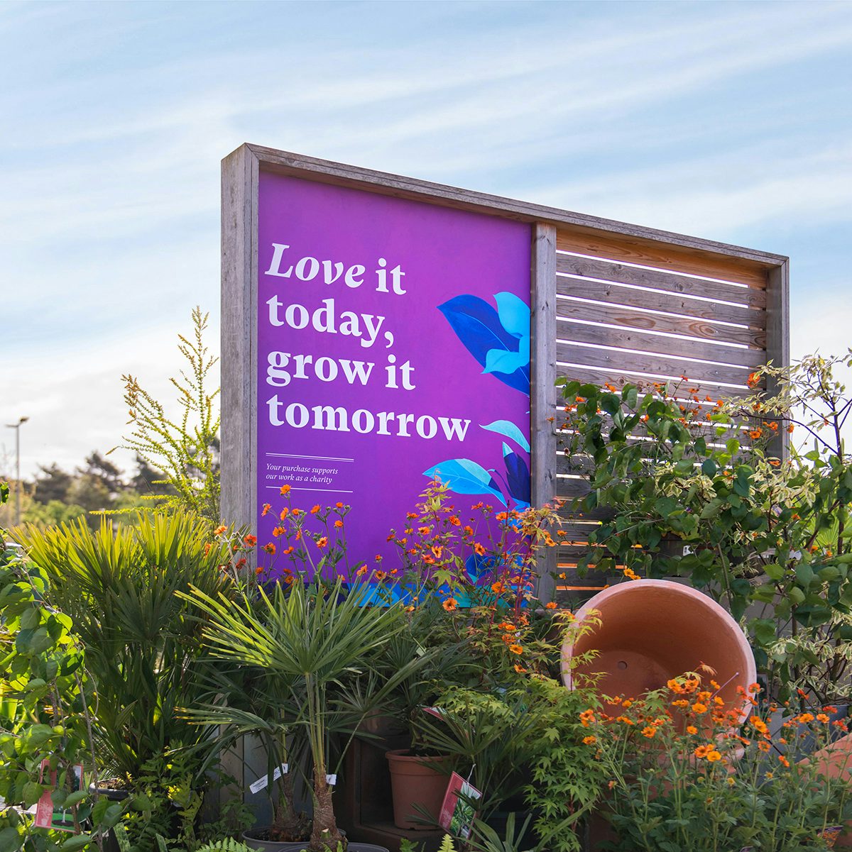 Photograph of RHS outdoor signage, which reads "Love it today, grow it tomorrow", featuring the new visual identity by Design Bridge