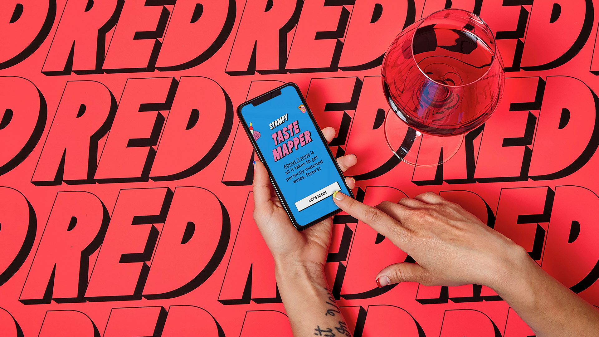 Photograph of the Stompy mobile website alongside a glass of wine, part of Stompy's branding by &Walsh