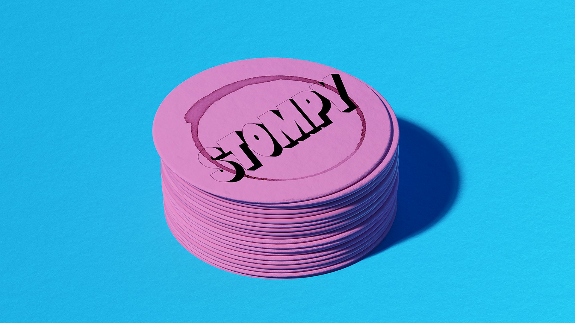Photograph of a stack of pink coasters with Stompy branding by &Walsh