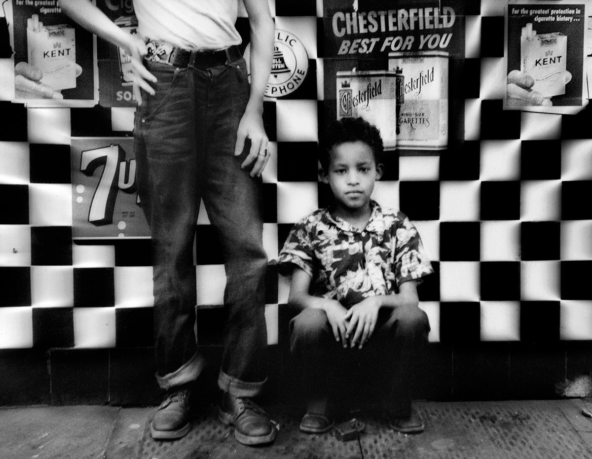 Black and white photograph of a child outside of a candy store in 1955, as part of the new William Klein exhibition called YES at the ICP