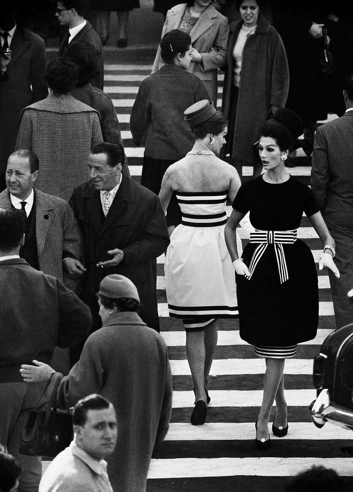 Black and white photograph of two women crossing each other on a busy pedestrian crossing, as part of the new William Klein exhibition called YES at the ICP