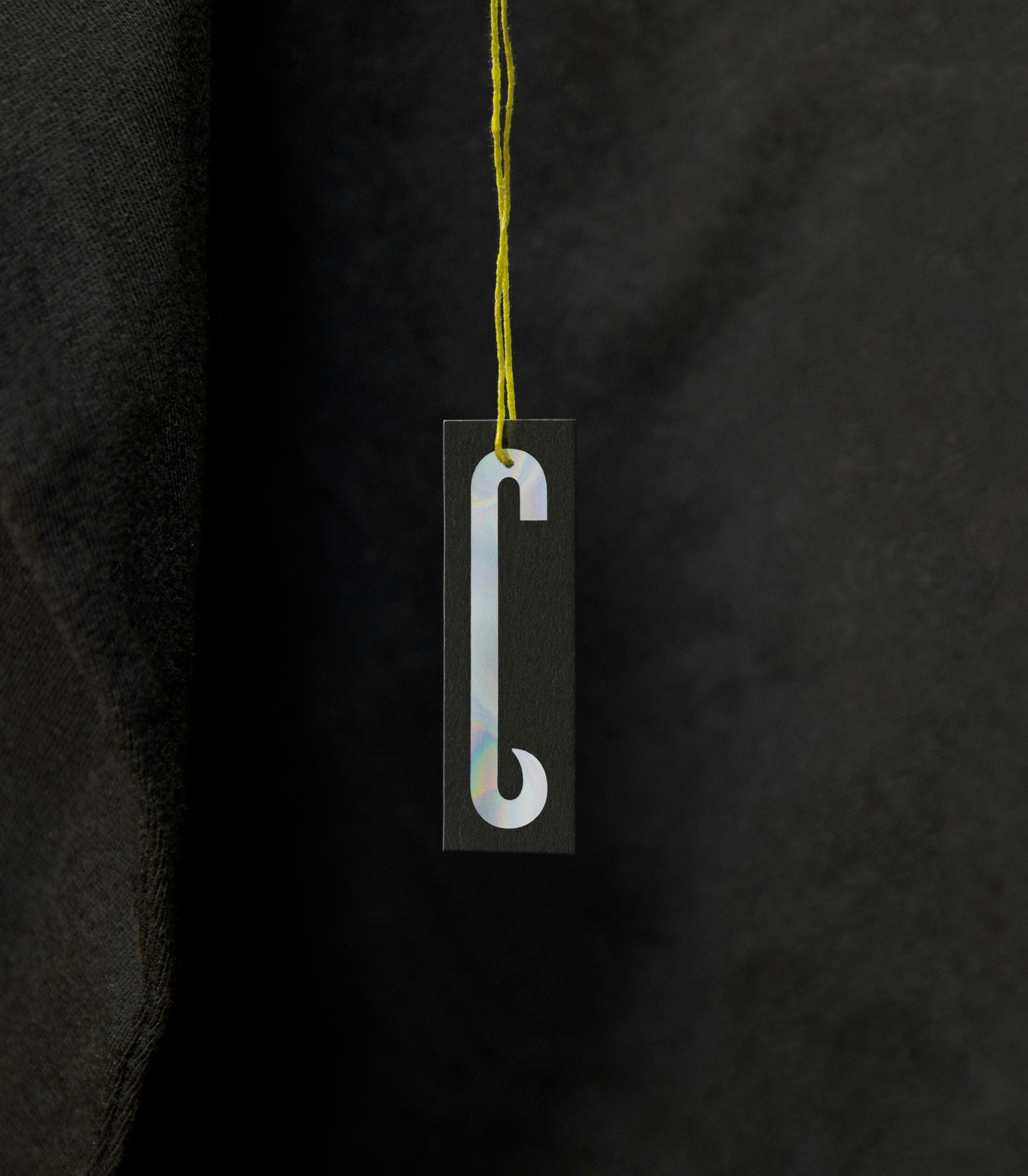 Photograph of a Big C Charters tag, with the elongated 'C' logo