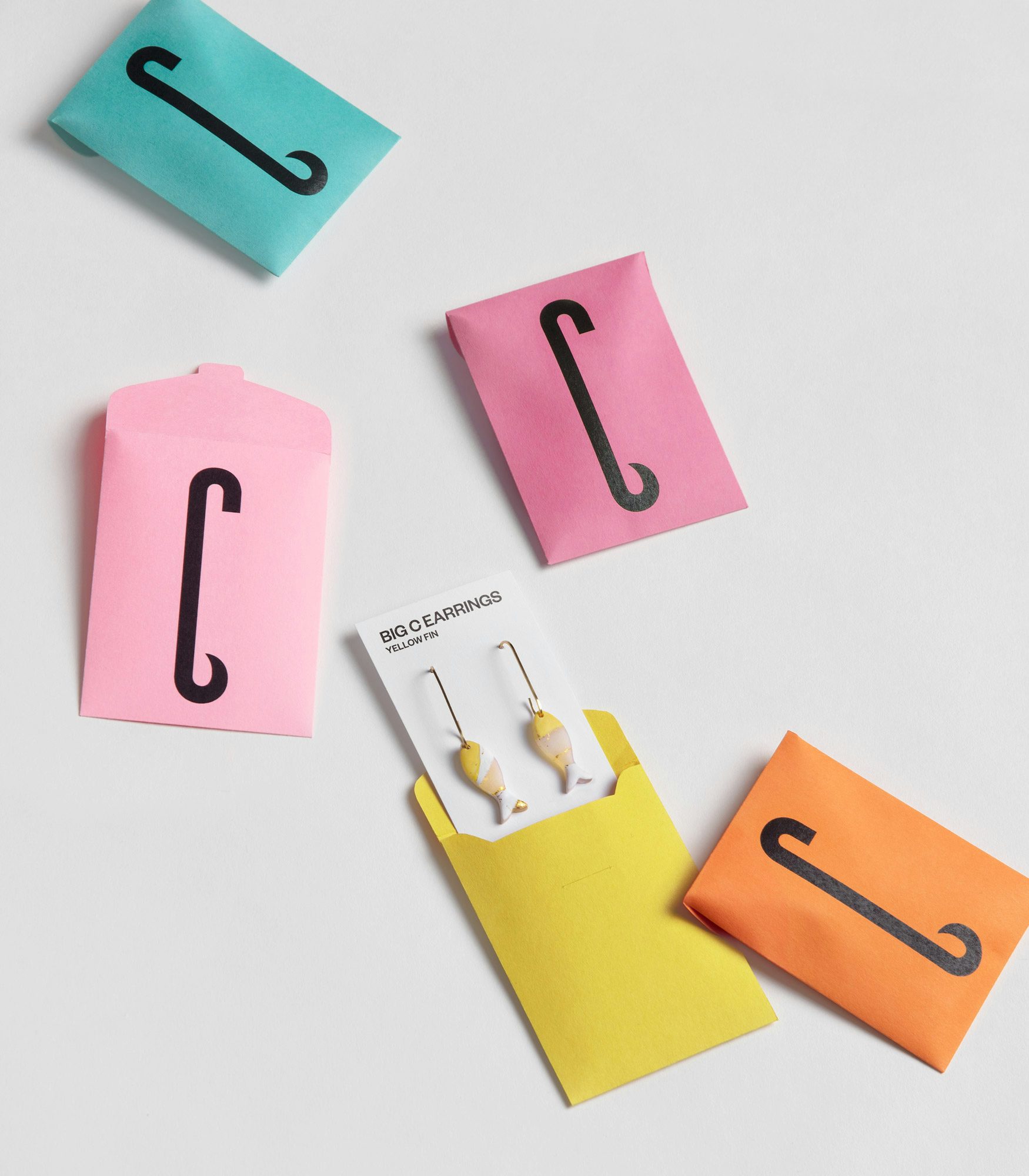 Photograph of earrings in the shape of fish created for Big C Charters