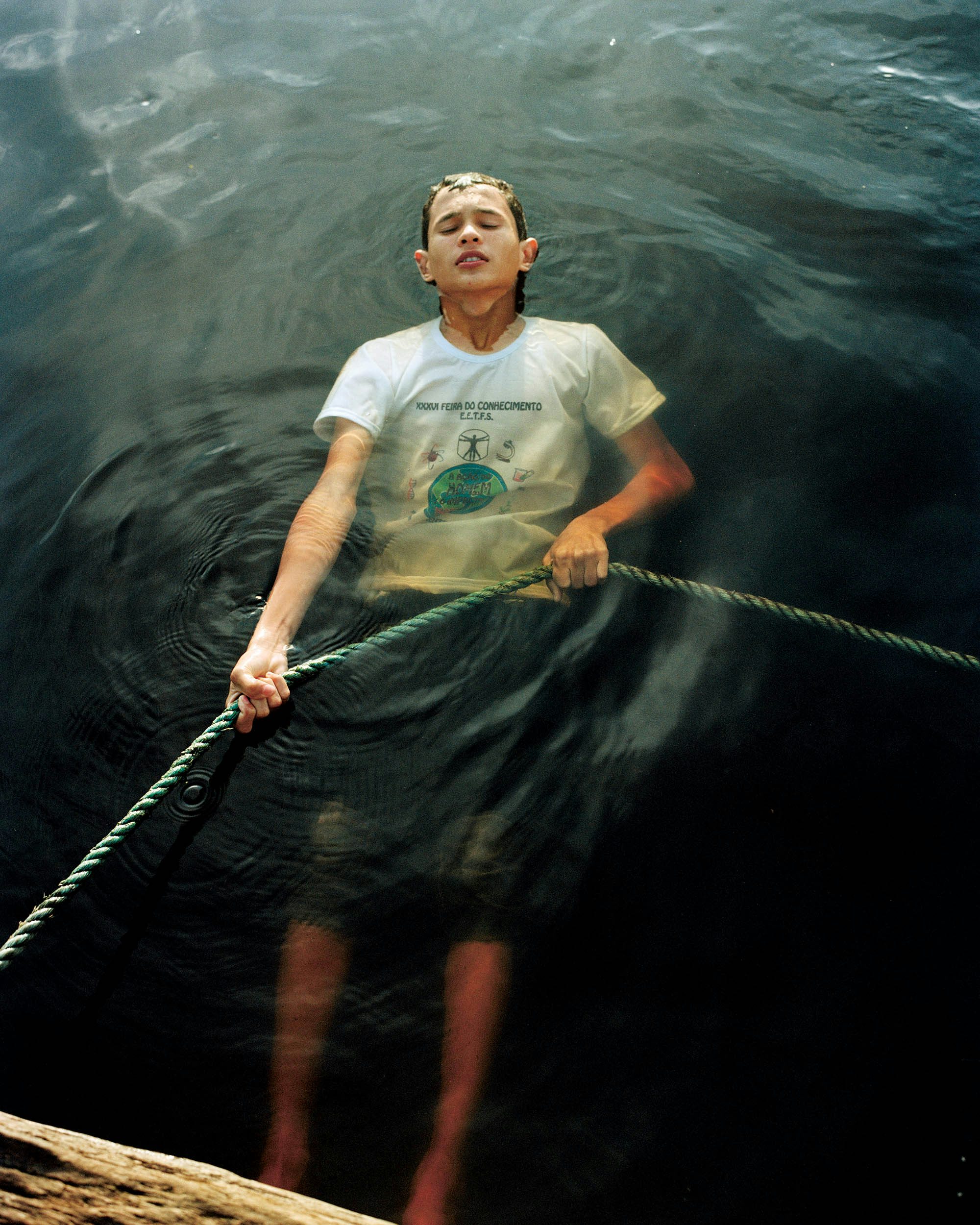 Photograph of a person floating in water holding a rope in Like a River by Daniel Jack Lyons