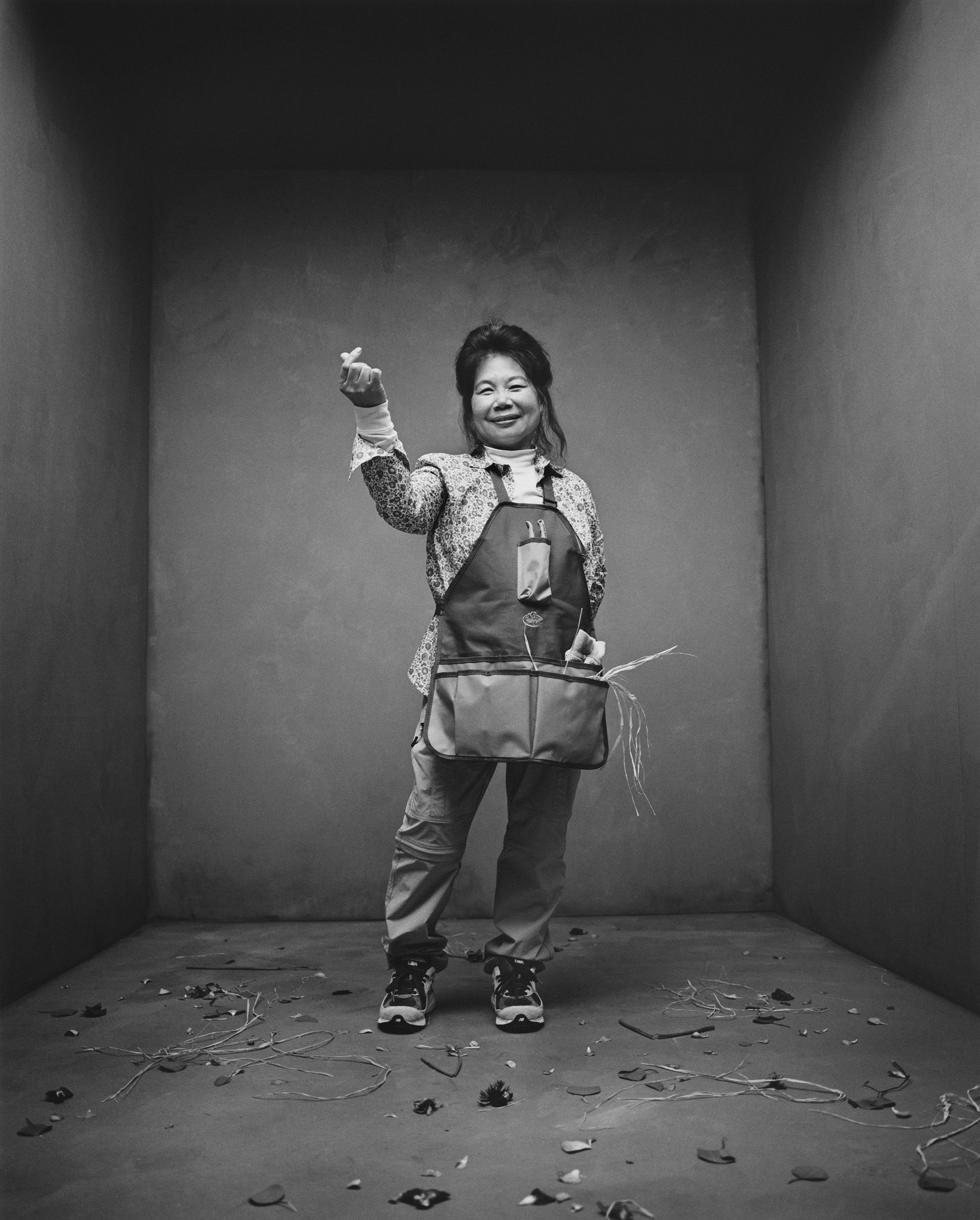 Black and white photograph of a person wearing dungarees, as part of New Balance's SS22 campaign