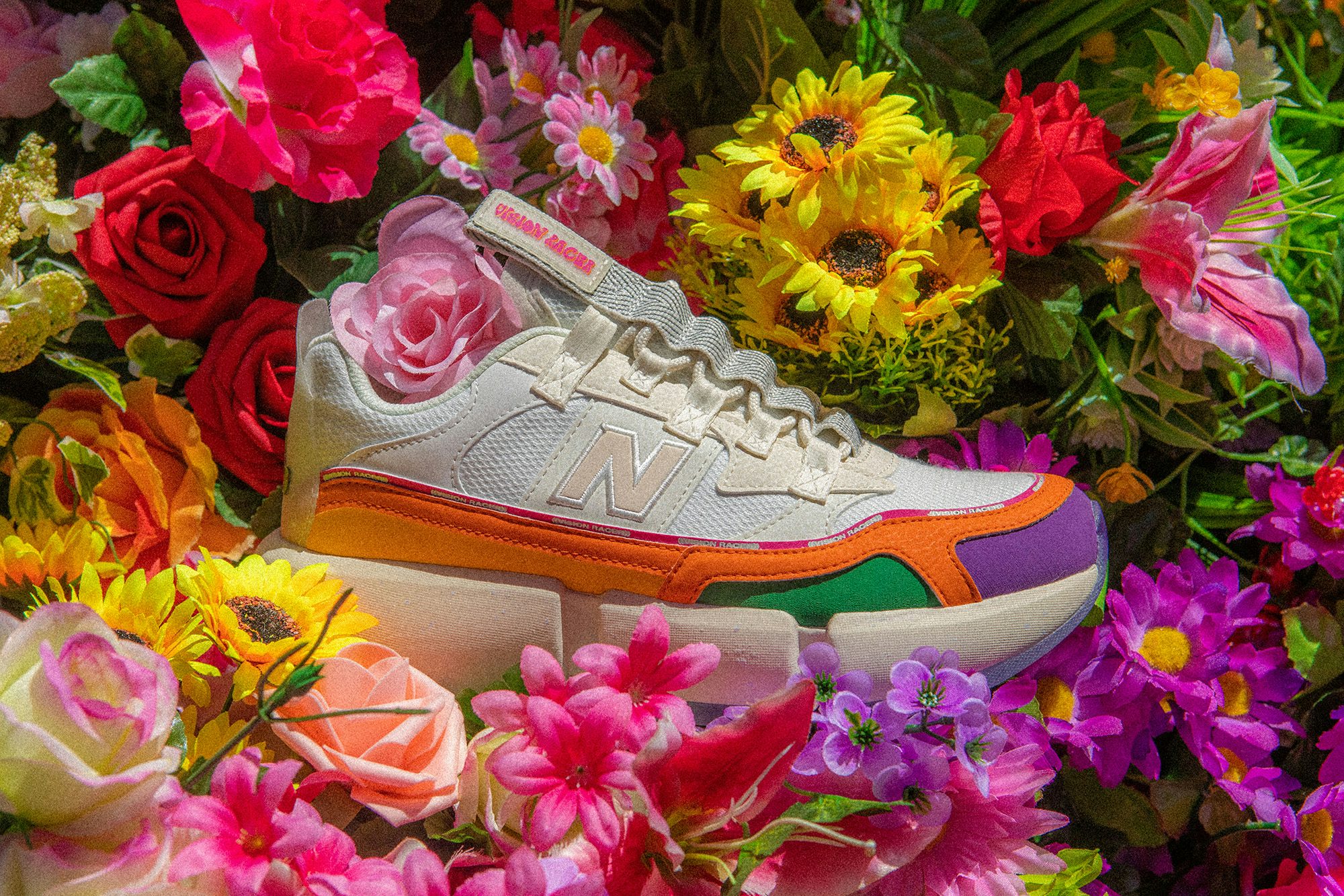 Photograph of the New Balance x Jaden Smith trainer surrounded by colourful flowers