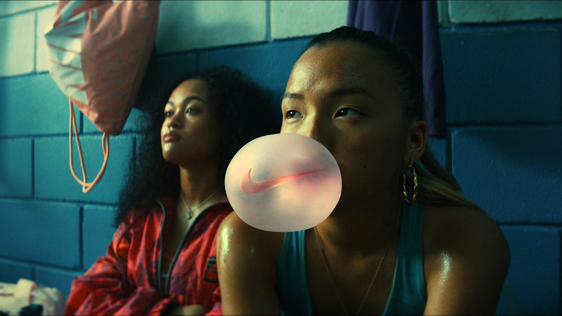 Still of a woman blowing bubble gum with the Nike logo in Nike's Never Settle, Never Done campaign for the Euros 2022