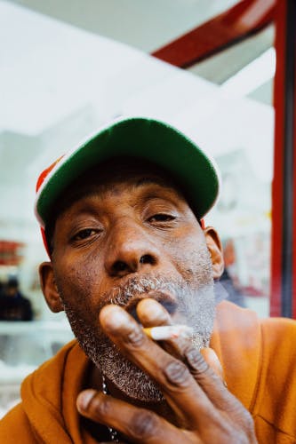 Photograph of a person smoking a cigarette by Jeremiah Babatunde