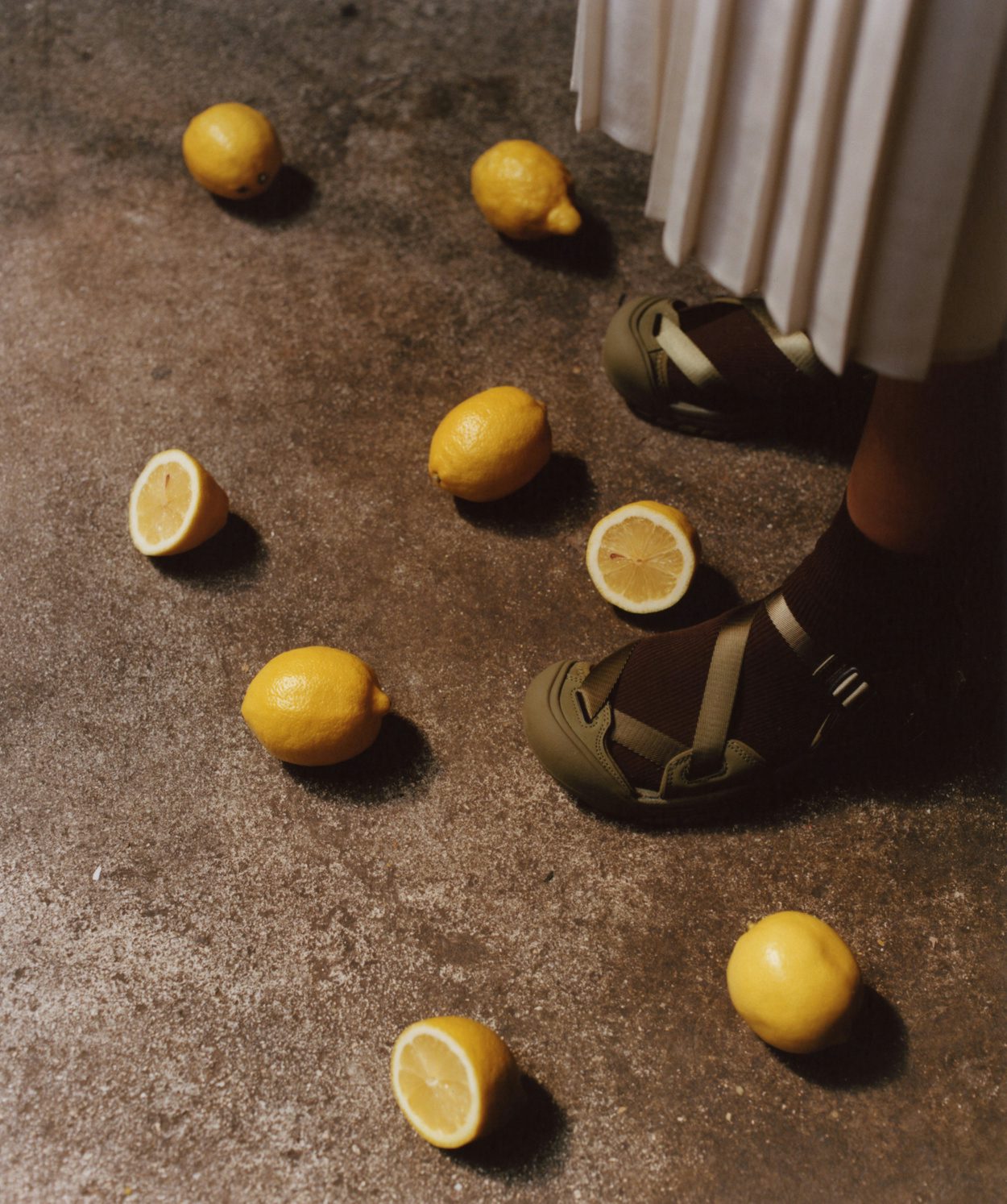 Photograph by Niall Hodson of cut lemons on the floor