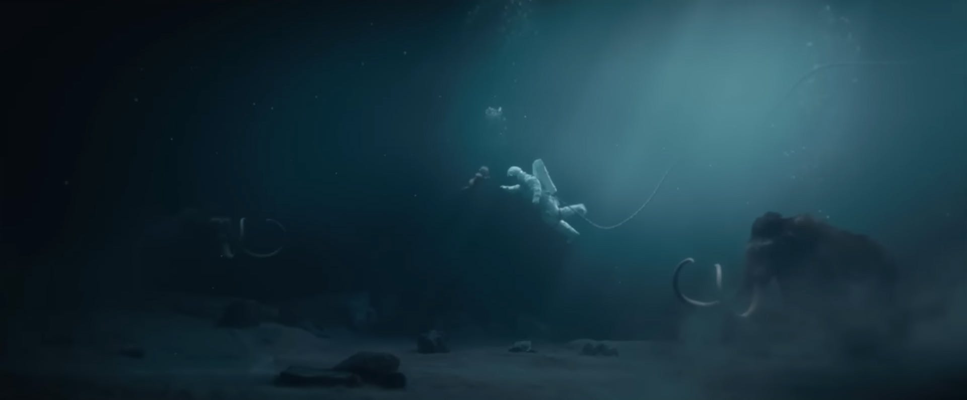 Still from Royal Ontario Museum's ad showing a baby underwater facing an astronaut