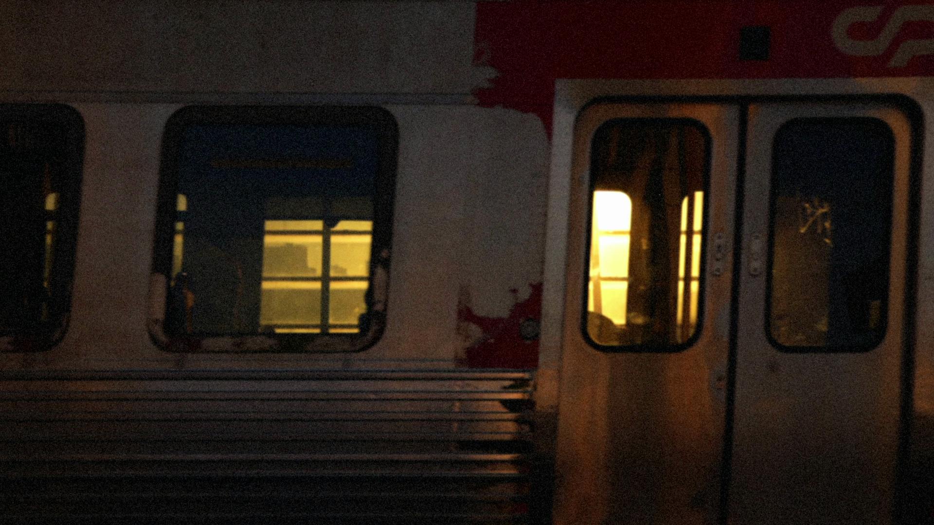 Still image of a passing train carriage from the music video for ATK by Bonobo