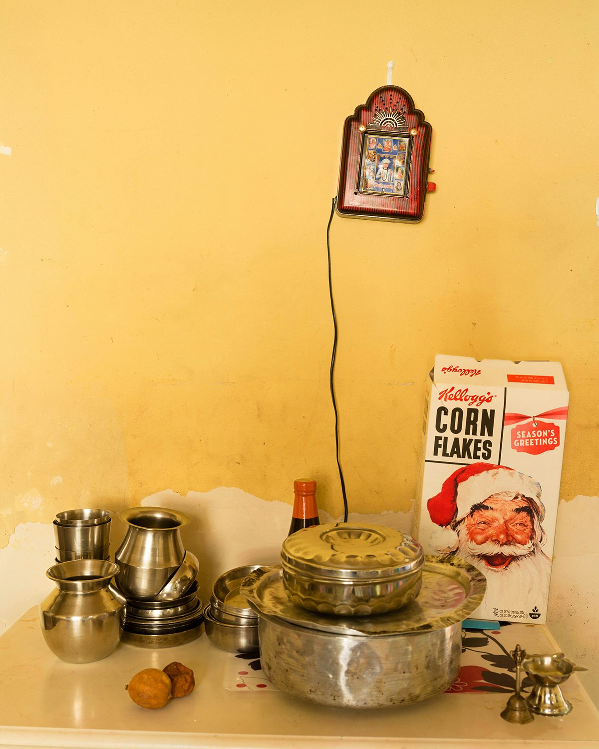 Image shows kitchenware and a box of Cornflakes, taken from Kavi Pujara's book This Golden Mile