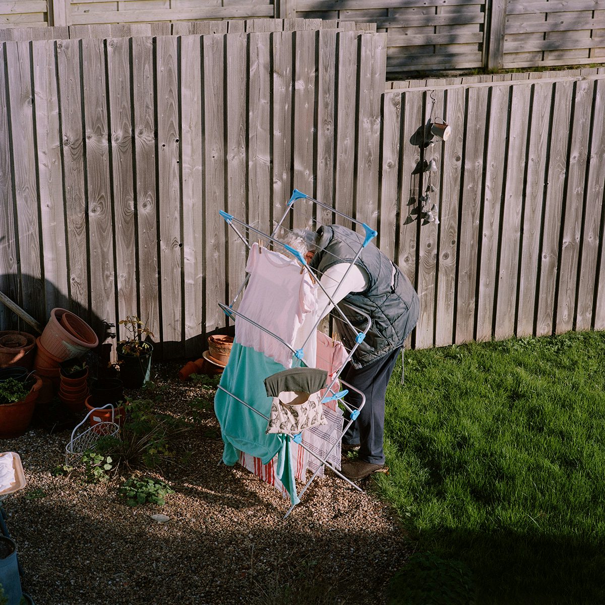 Image shows Pauline hanging out laundry in her garden, photographed by Taylor Wessing prize winner 2022, Clementine Schneidermann