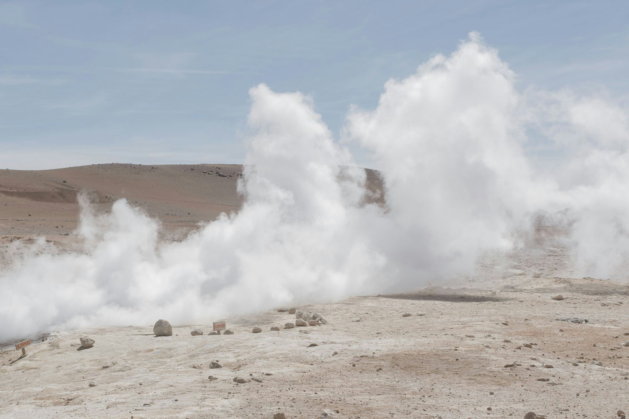 Image by River Claure showing a cloud of smoke filling a desert landscape