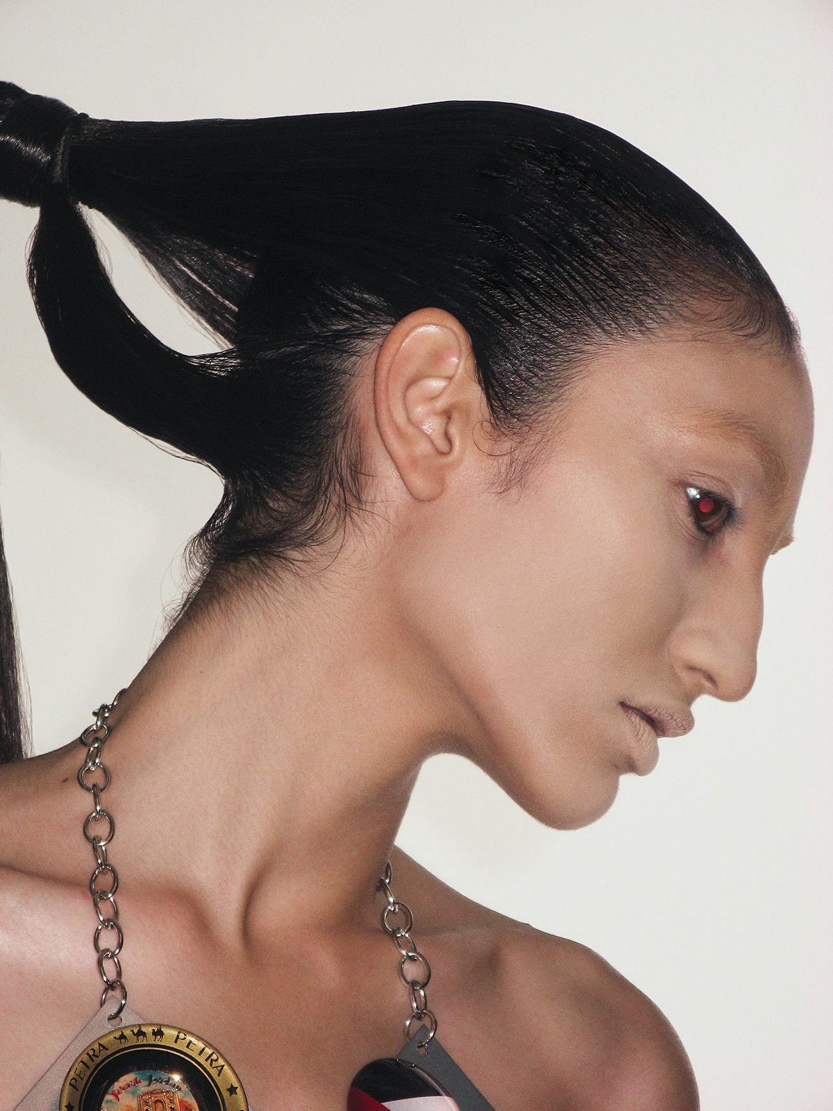 Image by Harley Weir of the profile of a model wearing a thick neck chain