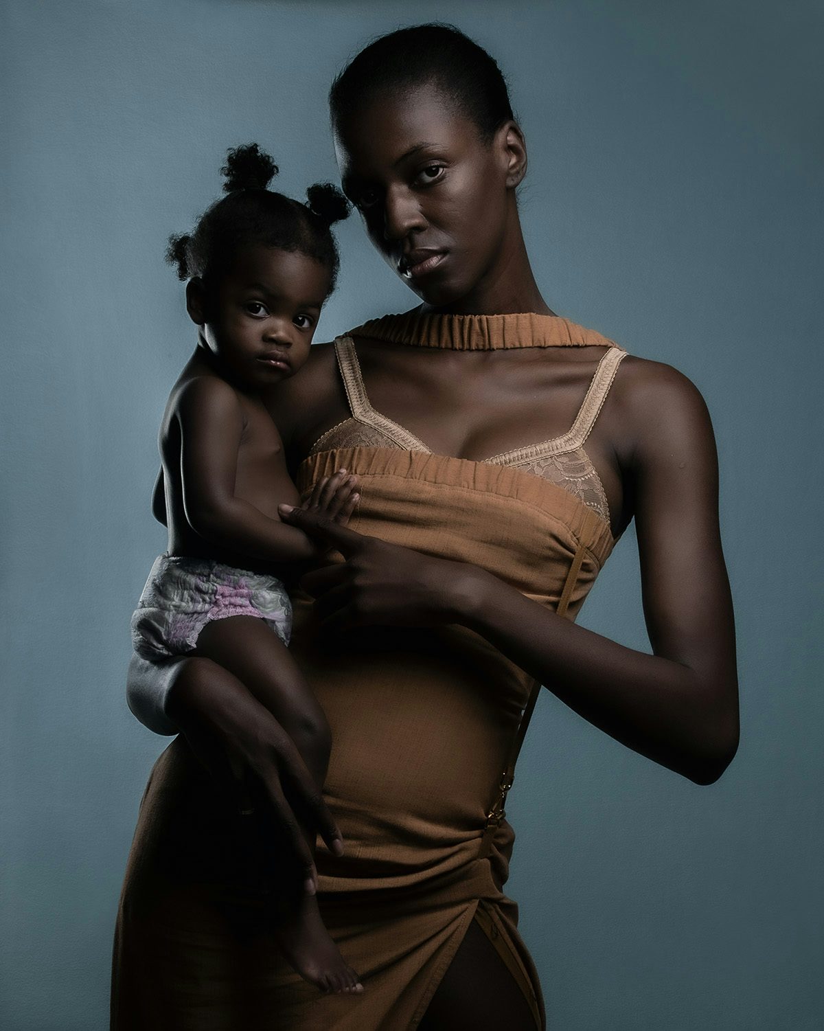 Image by Jet Swan shows a mother holding her baby