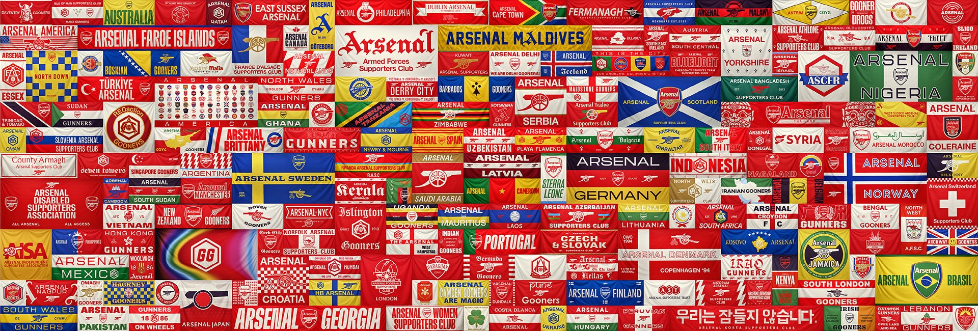 Image shows an Arsenal artwork by Jeremy Deller comprising over 100 various flags and banners brought together in a tapestry