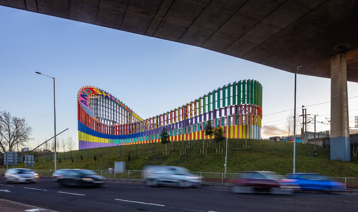 Image shows the colourful exterior of the Brent Cross Town electrical substation designed by artist Lakwena