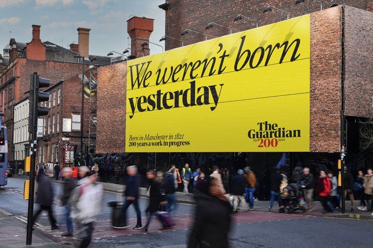 Image shows a yellow billboard with the text 'We weren't born yesterday' as part of the Guardian anniversary campaign