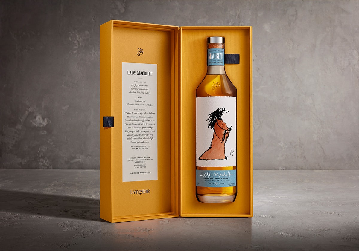 Photograph of a bottle in the Macbeth whisky collection featuring an illustration on the label of Lady Macduff drawn as a bird by Quentin Blake. The bottle is inside an orange presentation box