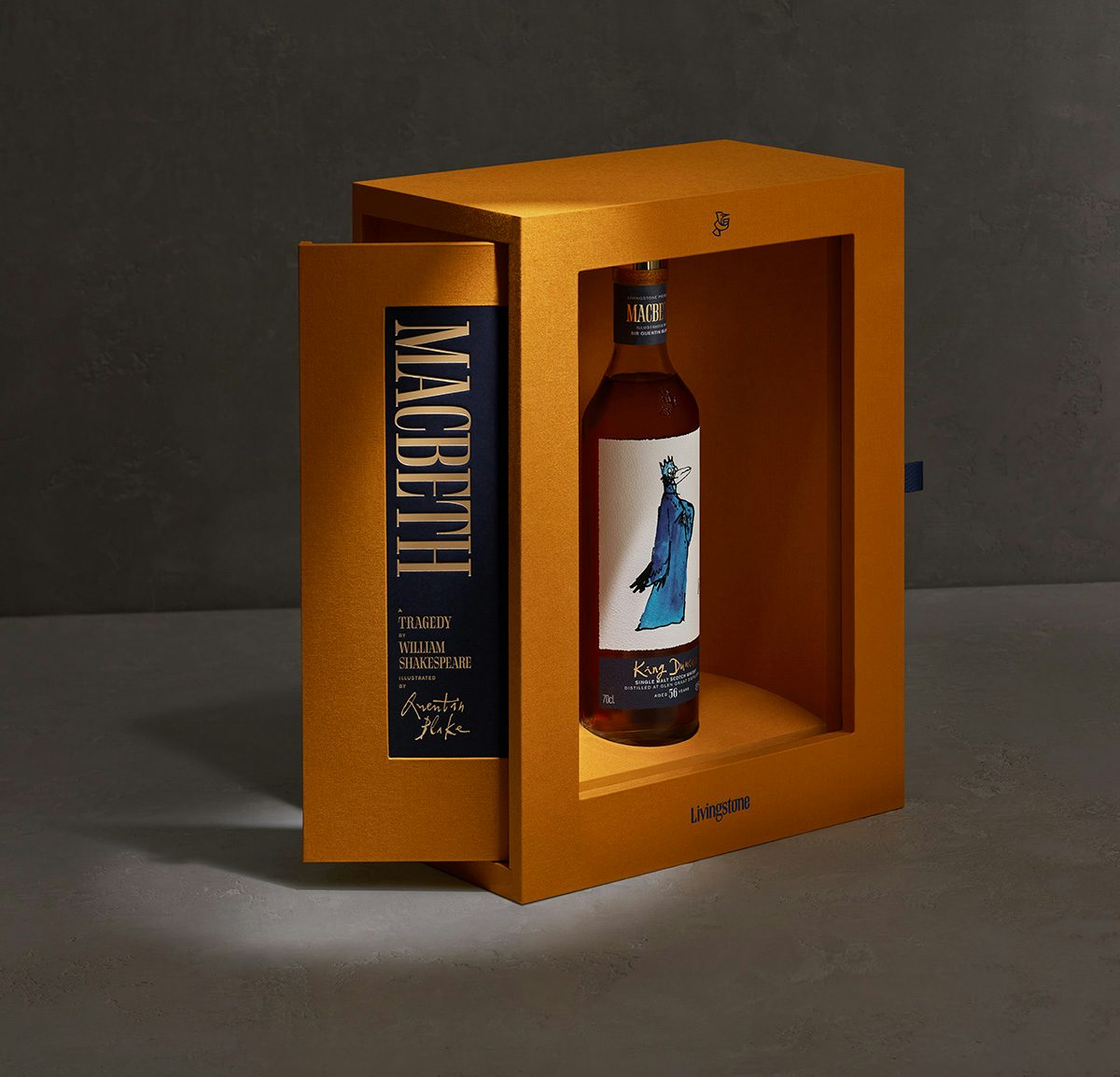 Photograph of a bottle in the Macbeth whisky collection featuring an illustration on the label of King Duncan drawn as a bird by Quentin Blake. The bottle is inside an orange presentation box