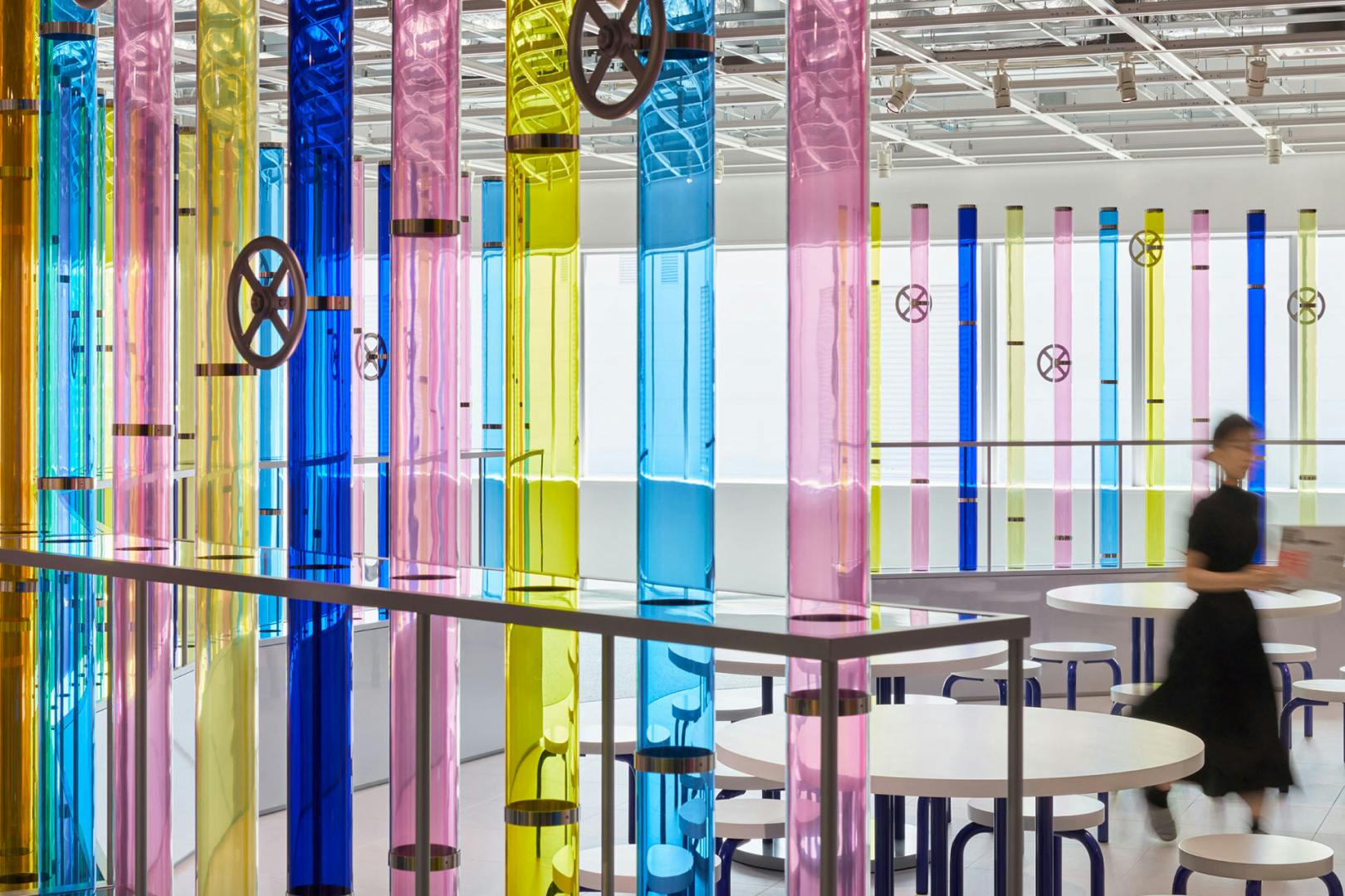 Photograph of Shiseido's Beauty Playground experience, showing large blue, yellow and pink glass panels that resemble test tubes