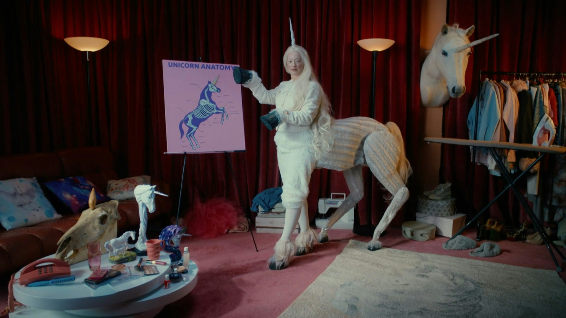 Still image from a BBC Bitesize campaign showing a person dressed in a unicorn costume doing a presentation