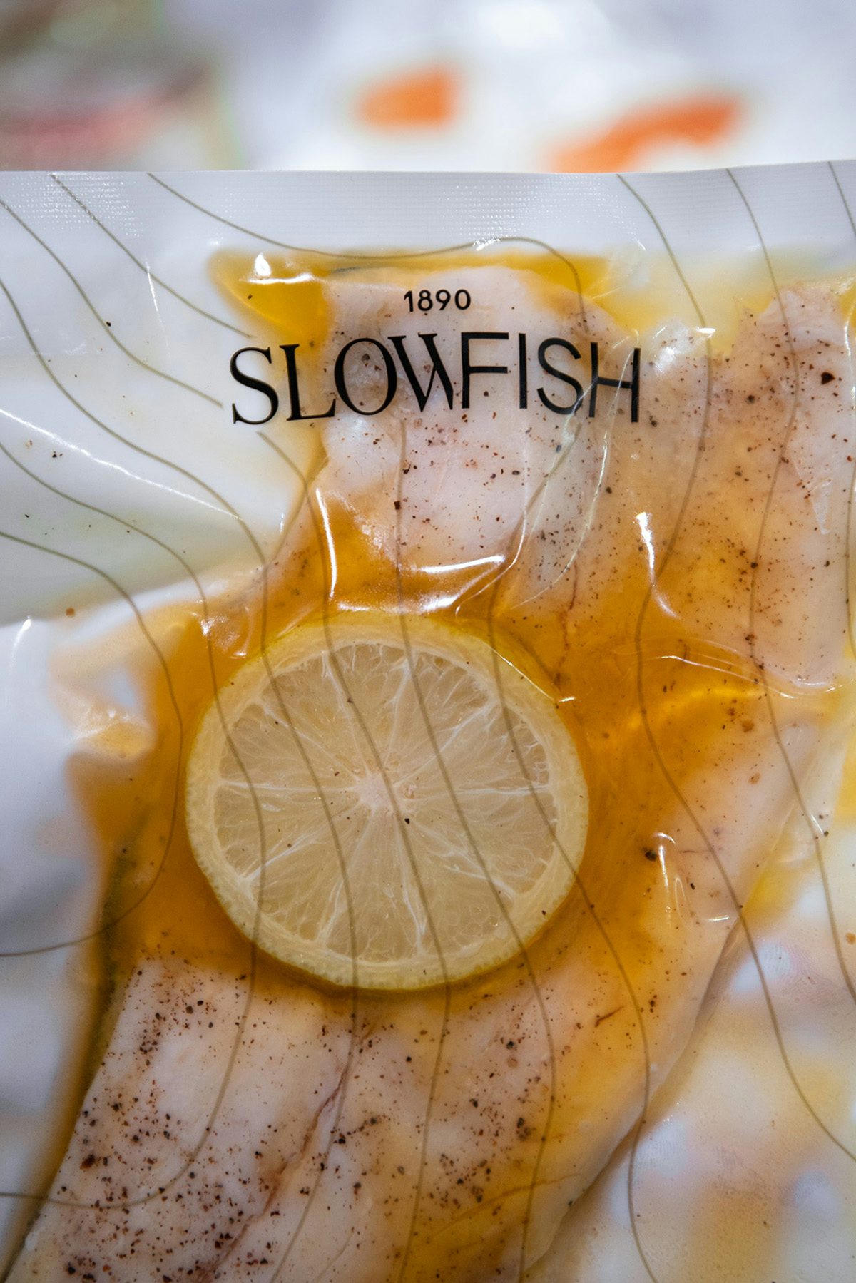 Photograph of packaged fish with featuring the Slowfish branding by Vasava