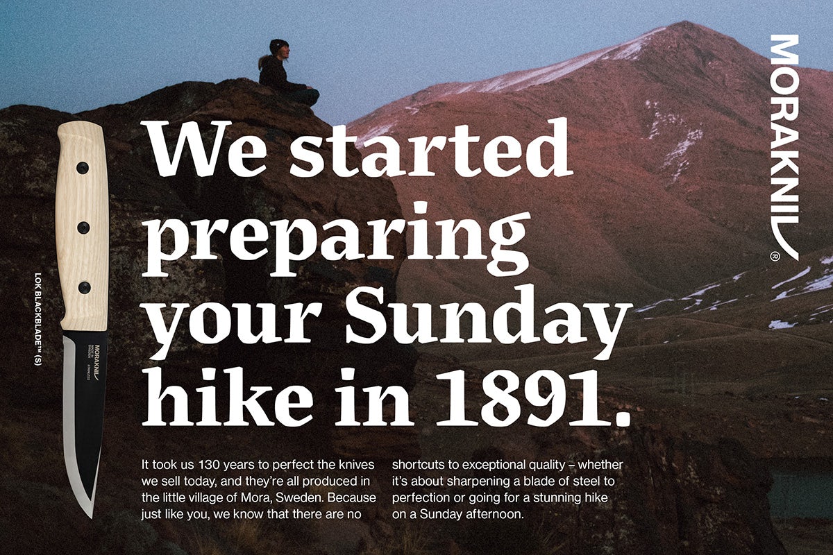 Image shows a photograph of a person sat atop a hillside looking over a hilly landscape, with the headline 'We started preparing your Sunday hike in 1891' written in the Morakniv typeface