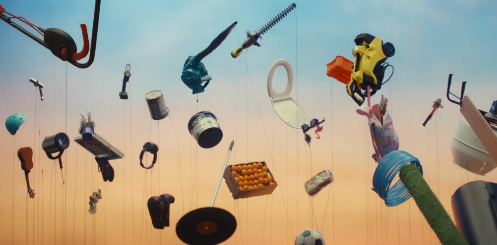 Image from B&Q's Prices Nailed campaign showing an array of household items appearing to float against a sunset hued backdrop