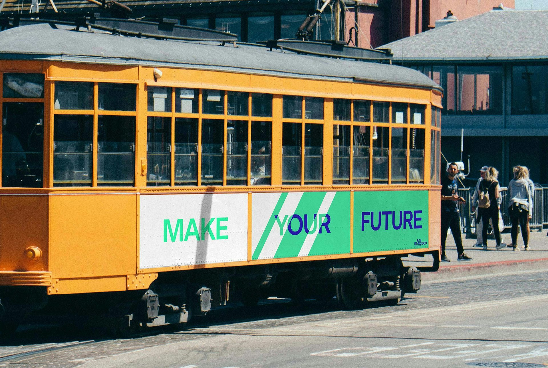 Photograph of a San Francisco tram that reads 'make your future' on a white and green striped background