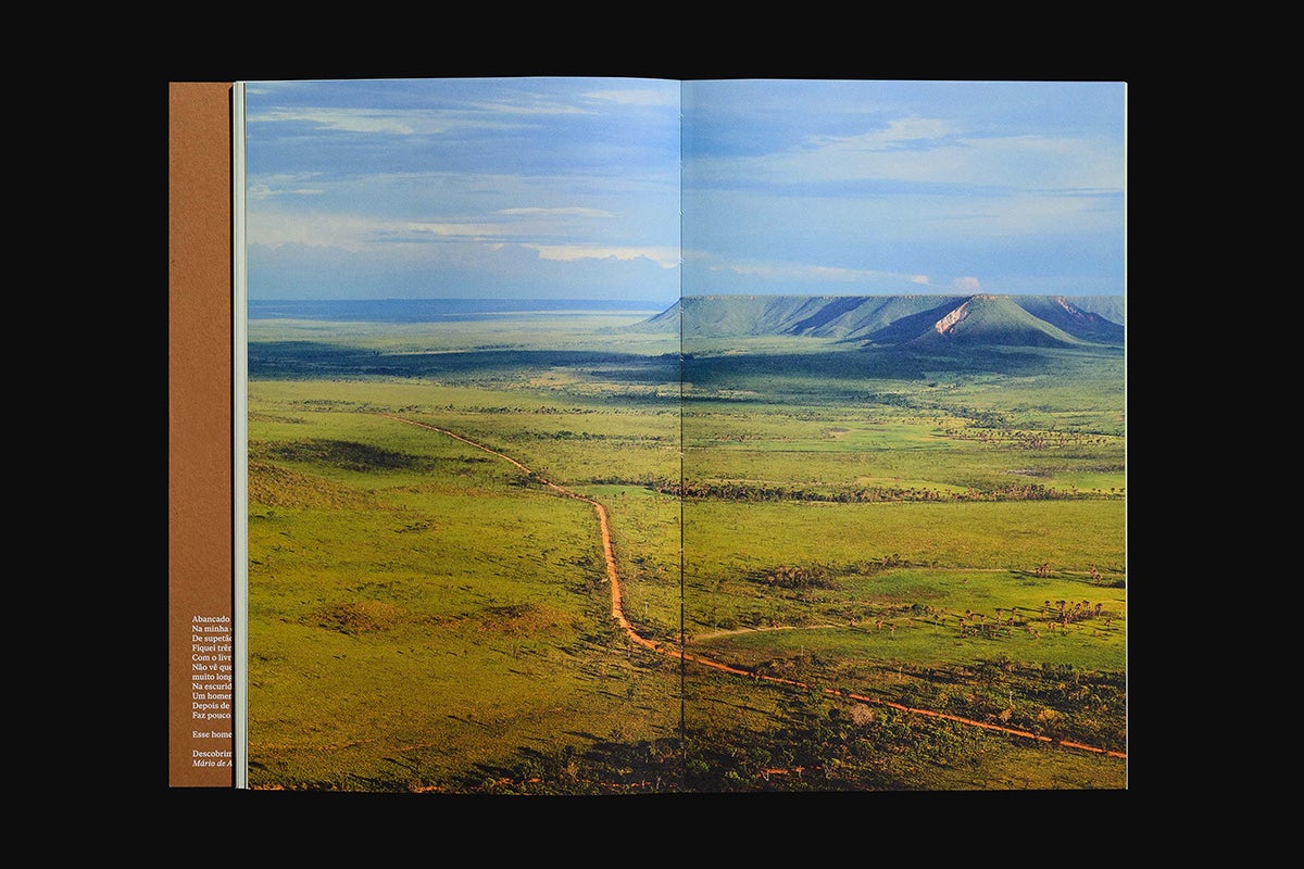 Spread from Quilo magazine showing a full-bleed landscape photograph with mountains in the background across both pages