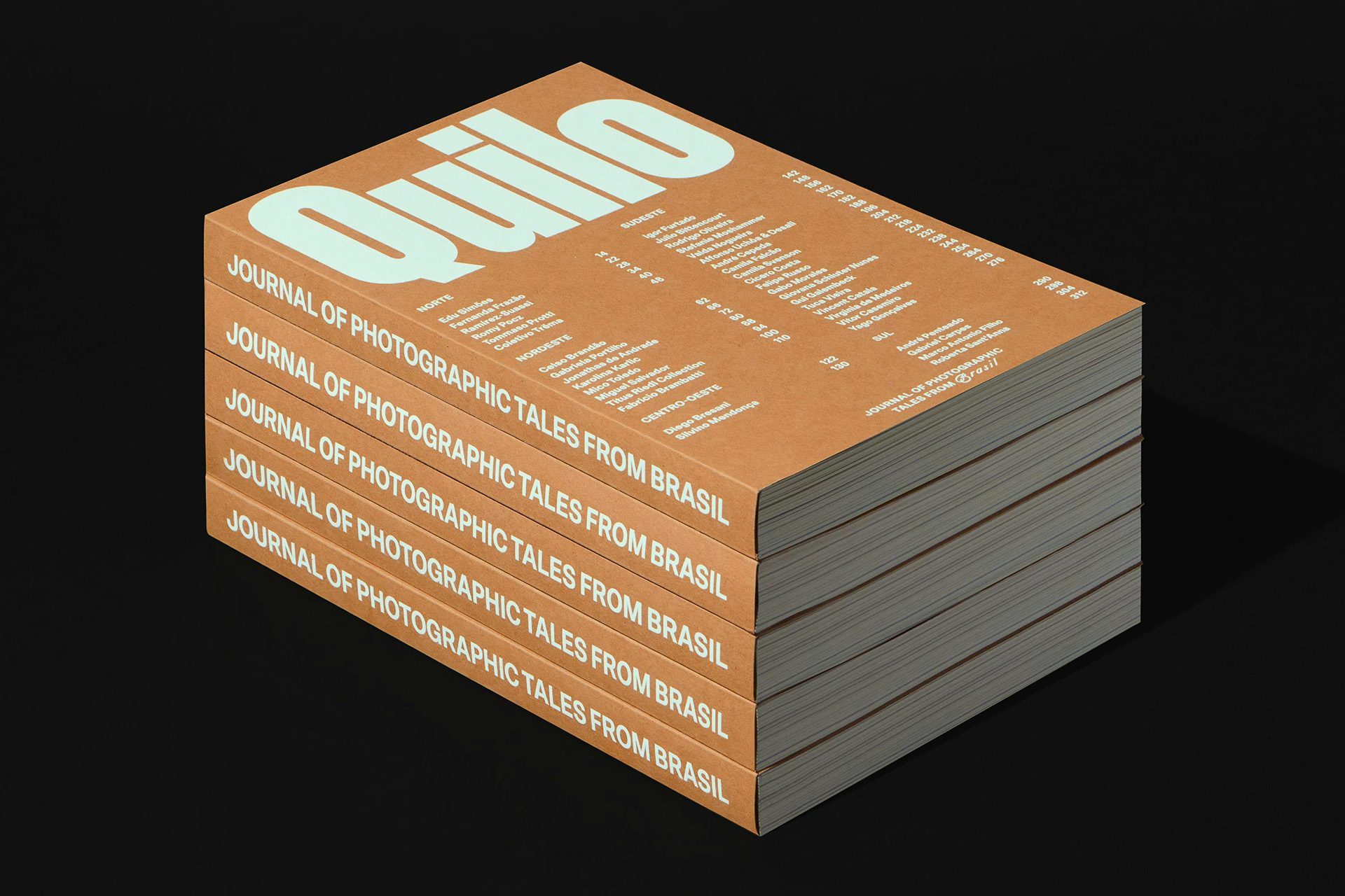 Photograph shows a stack of Quilo magazine with a orange-brown cover