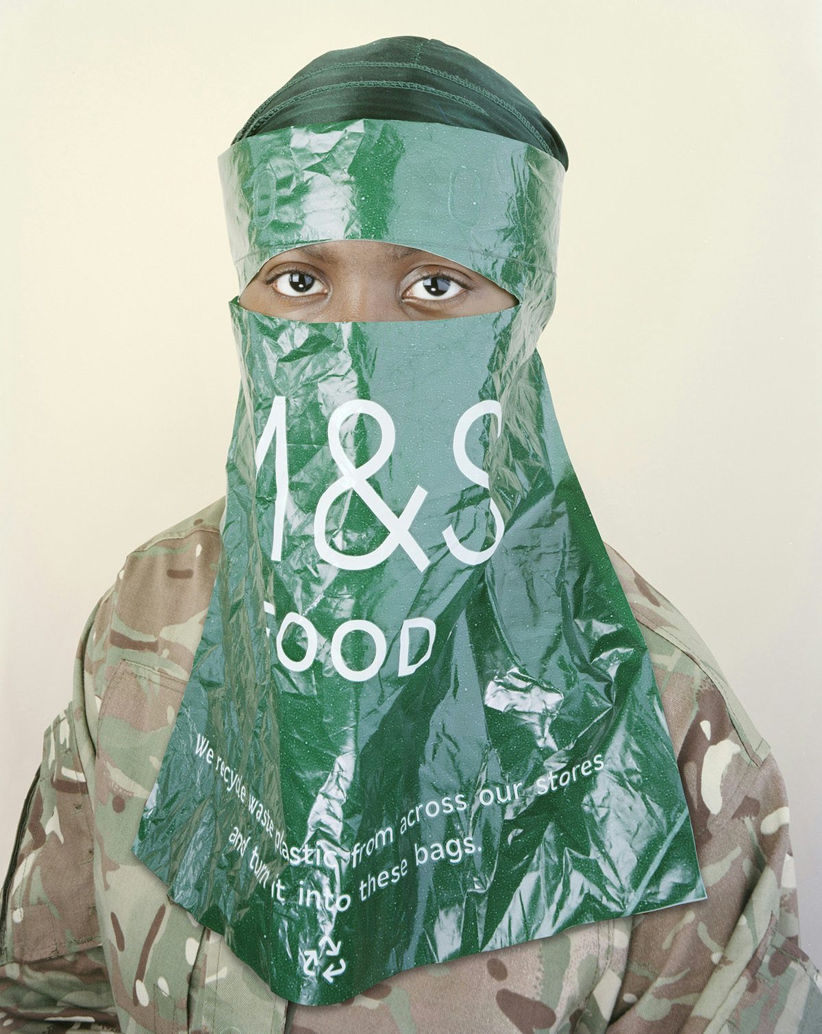 Photograph of a person wearing an M&S plastic bag over their face with space cut out for the eyes, part of the Sony World Photo Awards 2023