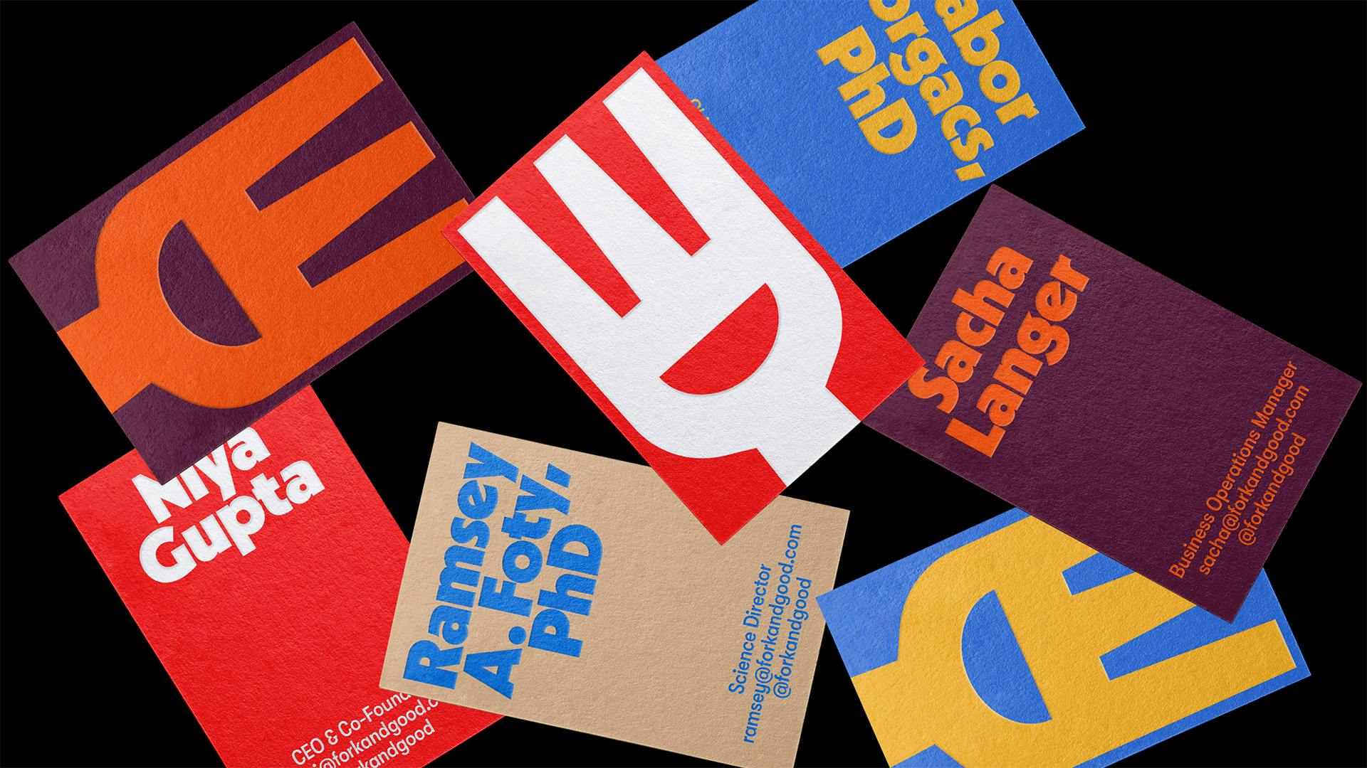 Image shows scattered poster designs for Fork & Good featuring its new branding and fork-shaped logo