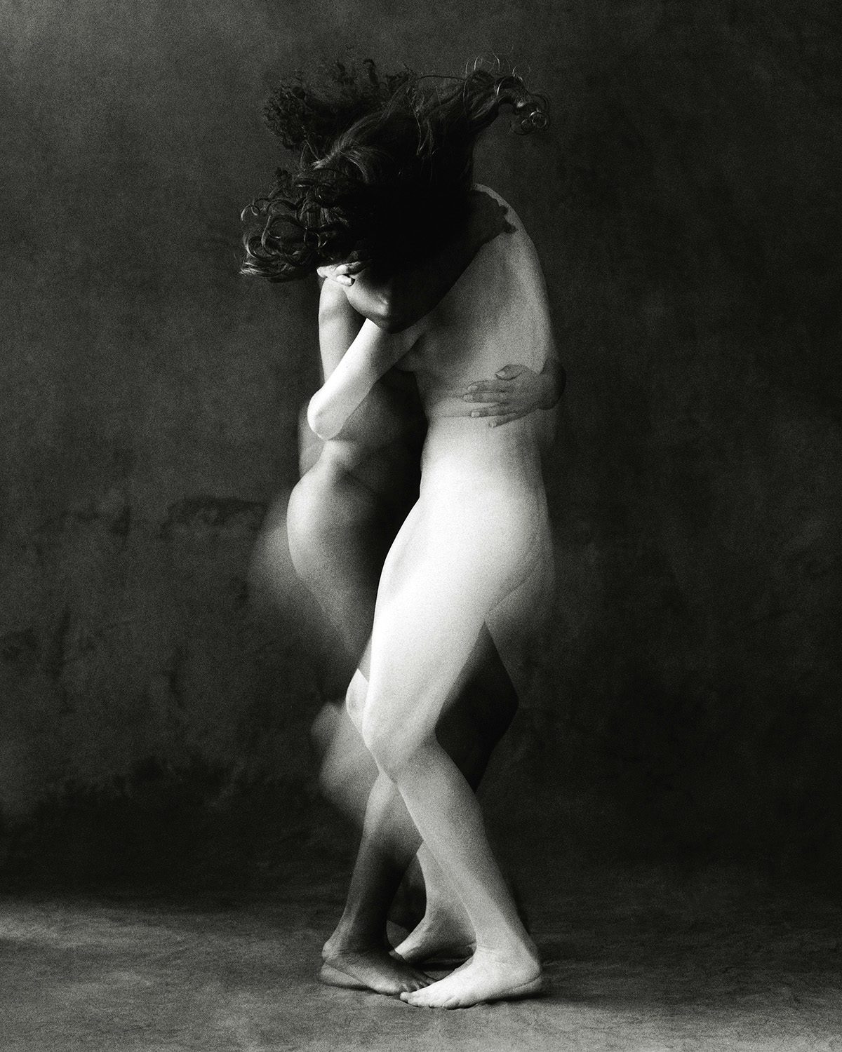 Black and white photograph from O by Luis Alberto Rodriguez, showing two nude bodies embracing one another with blurred effects