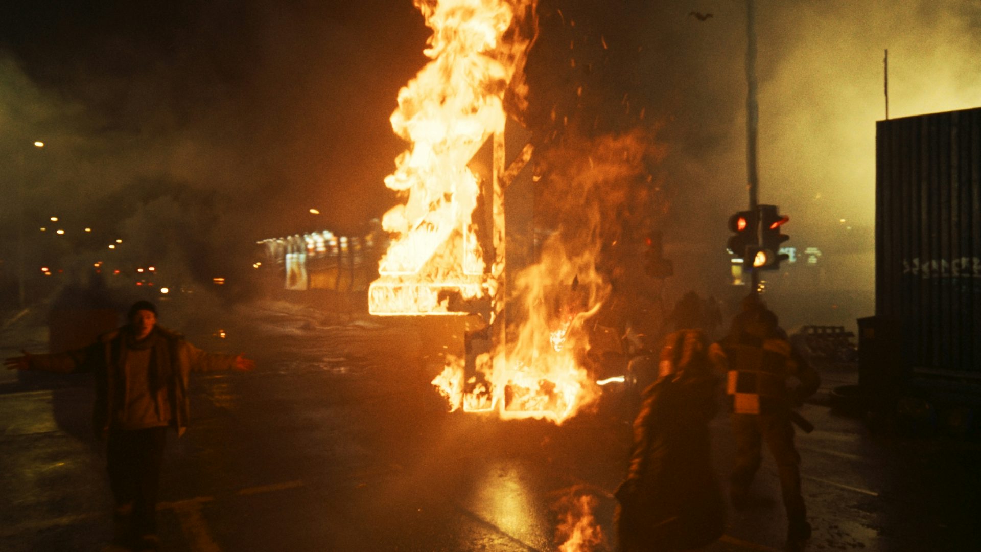 Still image from the new Channel 4 idents showing the 4 logo in flames at the centre of a dark street