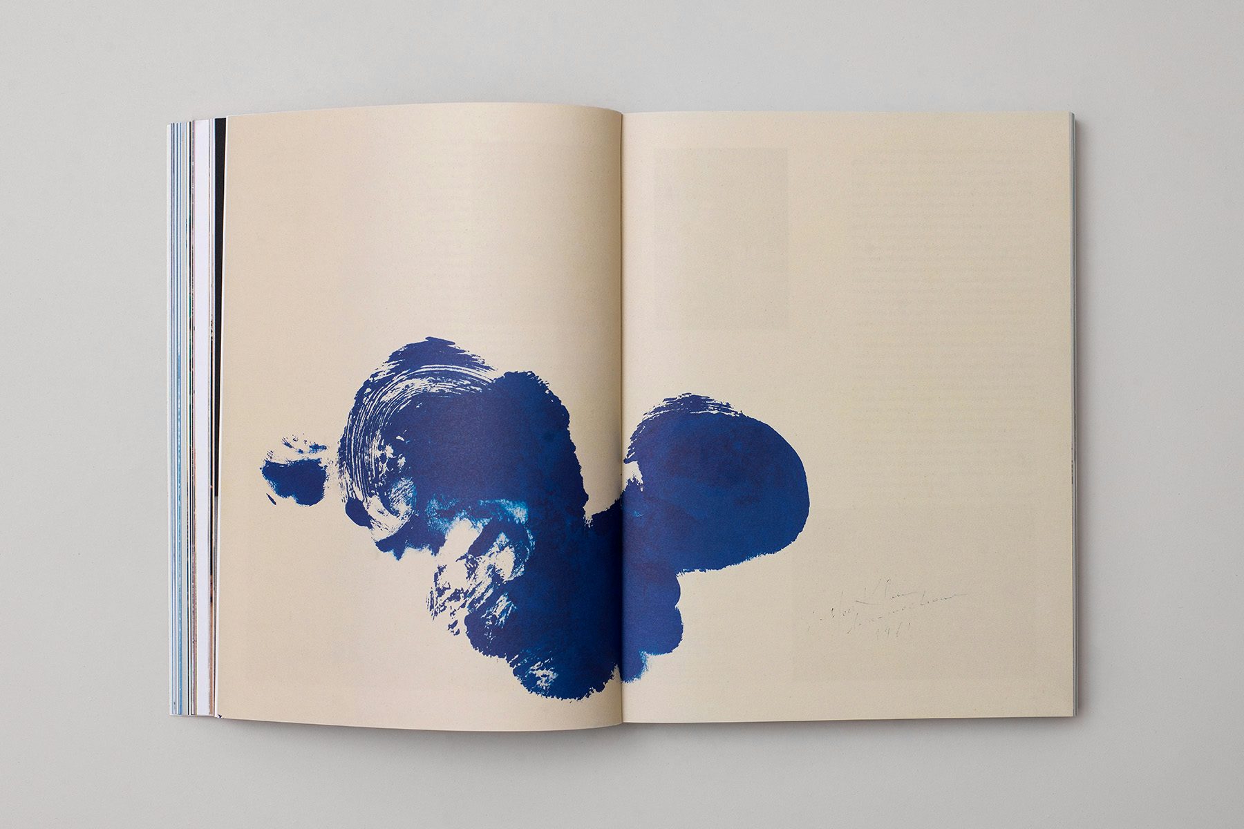 Photograph of a spread from the Blue issue of The Colour Journal, showing the image of dark blue smudged paint in the style of a rorschach image