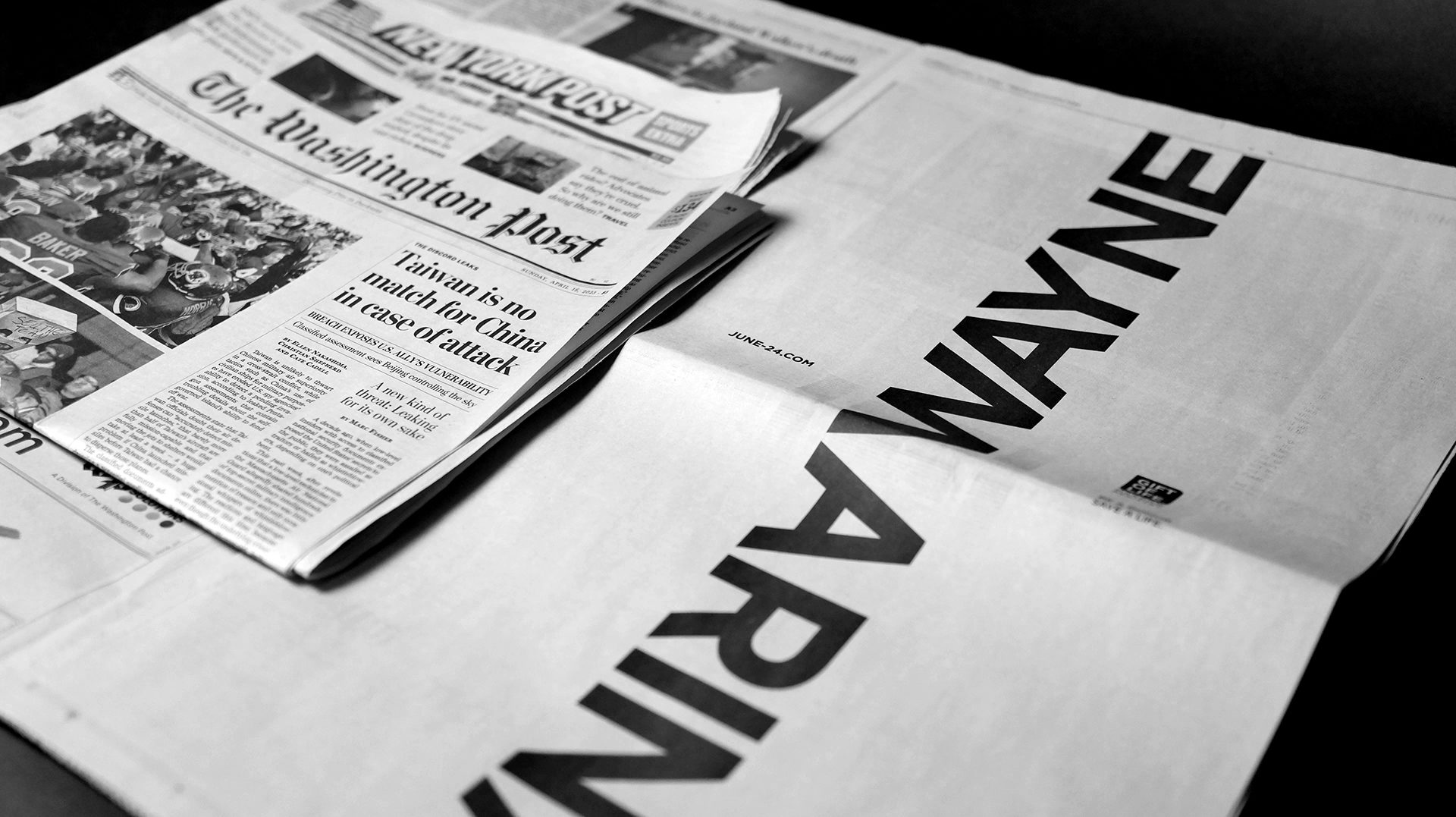 Photograph of a newspaper insert featuring the names Wayne and Marina joined in the middle by the letters 'M' and 'W'