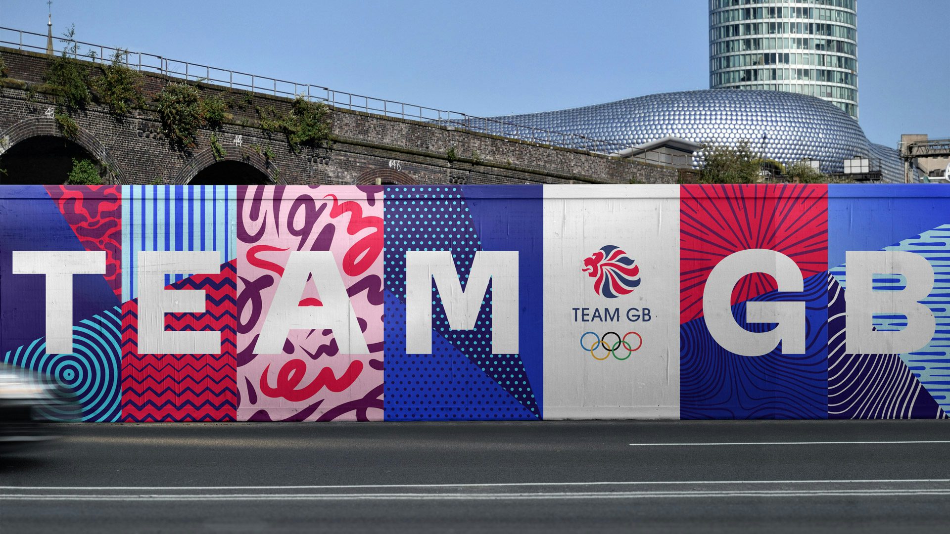 Graphic featuring the Team GB rebrand as shown on an outdoor billboard headlined 'Team GB', with different graphic patterns separating each letter