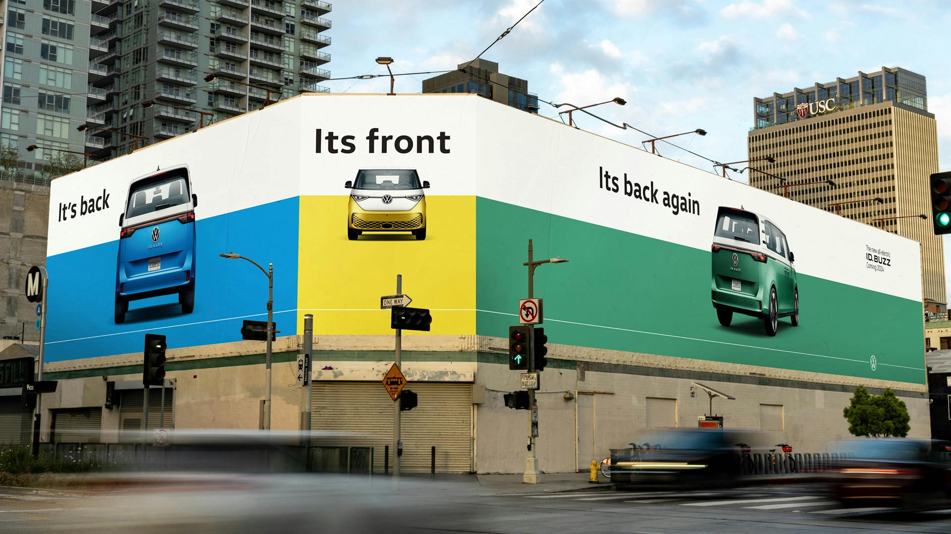 Photo shows a wraparound billboard at NYC port authority for VW's ID Buzz bus, with the lines 'It's back, its front, it's back again' above images of three VW buses in blue, yellow and green